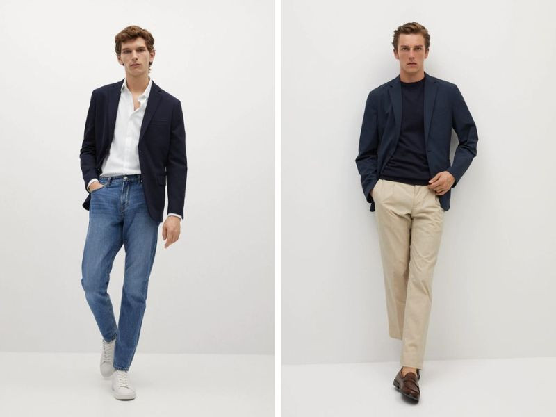Người mẫu nam mặc áo blazer màu xanh navy, áo thun trắng và quần jeans, tạo dáng đứng