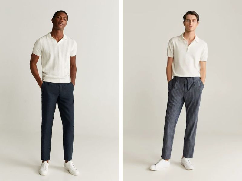 Người mẫu nam mặc áo polo màu xanh navy và quần tây màu be, tạo dáng thanh lịch